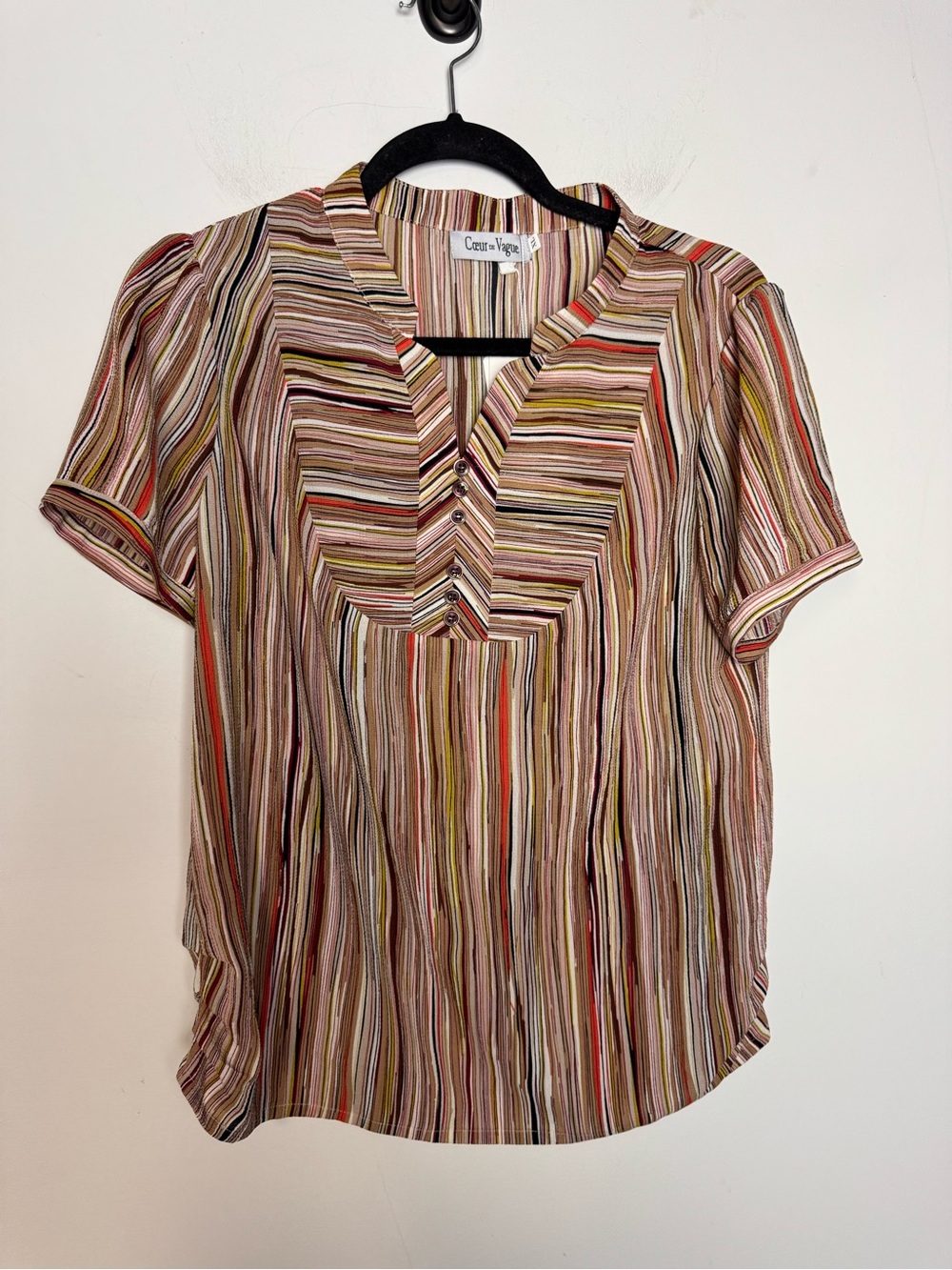 This Coeur de Vague top features a multi-colored striped pattern and a V-neck